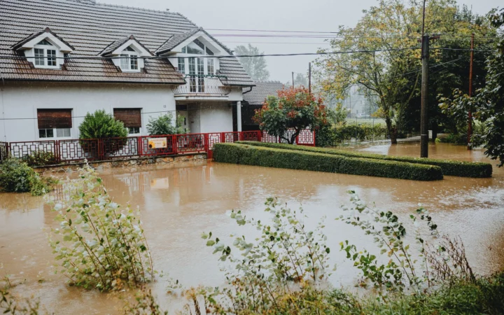 Flood water surrounding homes on a residential street